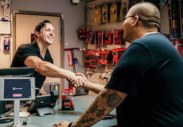 Service / Will Call Will Call counter teammate shaking hands with a customer