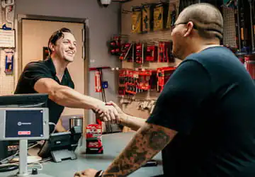 Service / Will Call Will Call counter teammate shaking hands with a customer